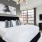 Modern furnished bedroom with natural lighting and high ceilings at Flats at Ponce City Market